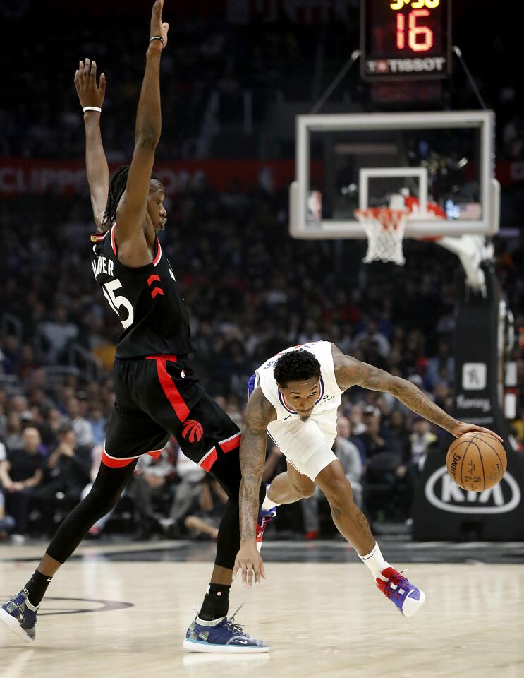 Clippers guard Lou Williams tries to get around Raptors forward Chris Boucher during a game Nov. 11 at Staples Center.