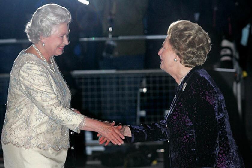 Former British Prime Minister Margaret Thatcher, right, greets Queen Elizabeth II as she arrives for Thatcher's 80th birthday party at the Mandarin Oriental Hotel in London.