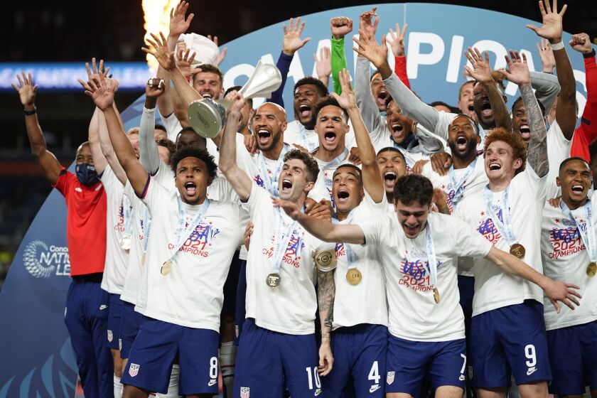 Members of the United States celebrate a 3-2 win against Mexico in extra time in the CONCACAF Nations League championship soccer match, Sunday, June 6, 2021, in Denver. (AP Photo/Jack Dempsey)