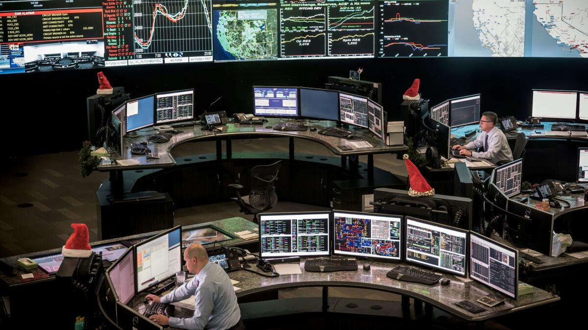 Workers in the Cal-ISO control center in Folsom monitor energy levels and prices across the California electrical grid. The center runs 24 hours a day.