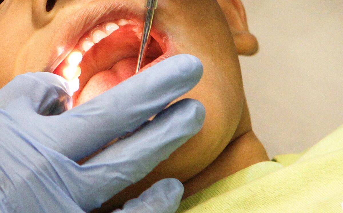 A boy gets cavities filled at a free health clinic in Los Angeles in 2012.