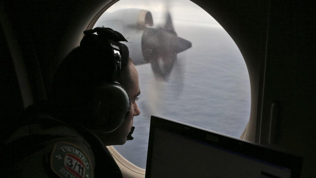 Rayan Gharazeddine of the Australian air force scans the water in the southern Indian Ocean off Australia during the search for the missing Malaysia Airlines Flight MH370 in 2014.