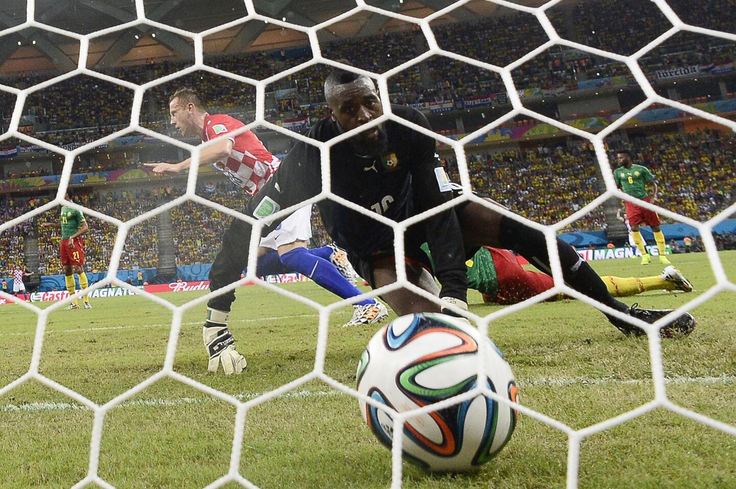 Cameroon's goalkeeper Charles Itandje looks at the ball after Croatia's forward Ivica Olic scores.