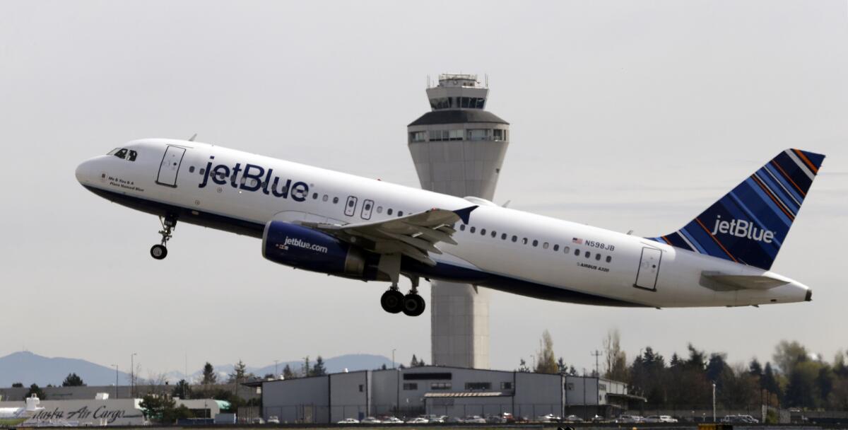A JetBlue flight takes off from Seattle-Tacoma International Airport. A man aboard a JetBlue flight from Anchorage to Portland, Ore., was arrested after urinating on fellow passengers, authorities said.