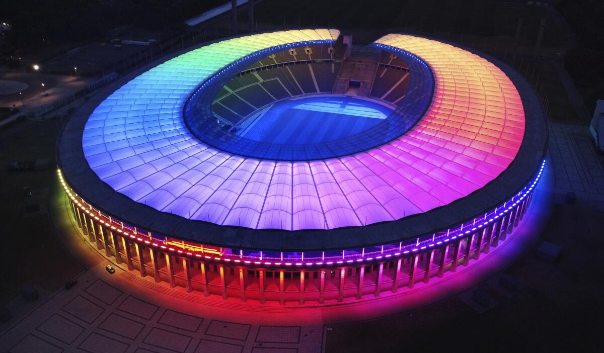 The rainbow-illuminated Olympic Stadium is p 