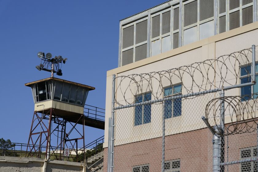 FILE - Barbed wire and a guard tower is seen at San Quentin State Prison on April 12, 2022, in San Quentin, Calif. California could reinstate voting rights to felons while they are in prison in a major expansion of suffrage for incarcerated people if a bill currently before the state legislature passes despite an uphill battle. (AP Photo/Eric Risberg,File)