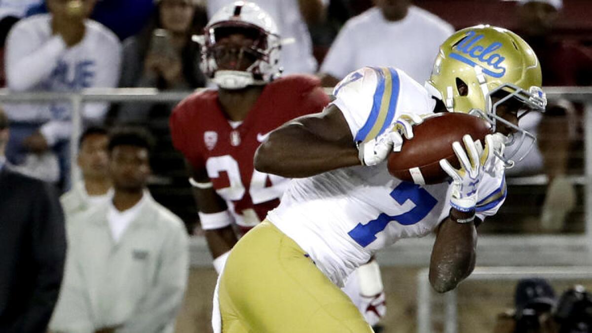 UCLA wide receiver Darren Andrews catches a touchdown pass during the first half. To see more images from the game, click on the photo above.