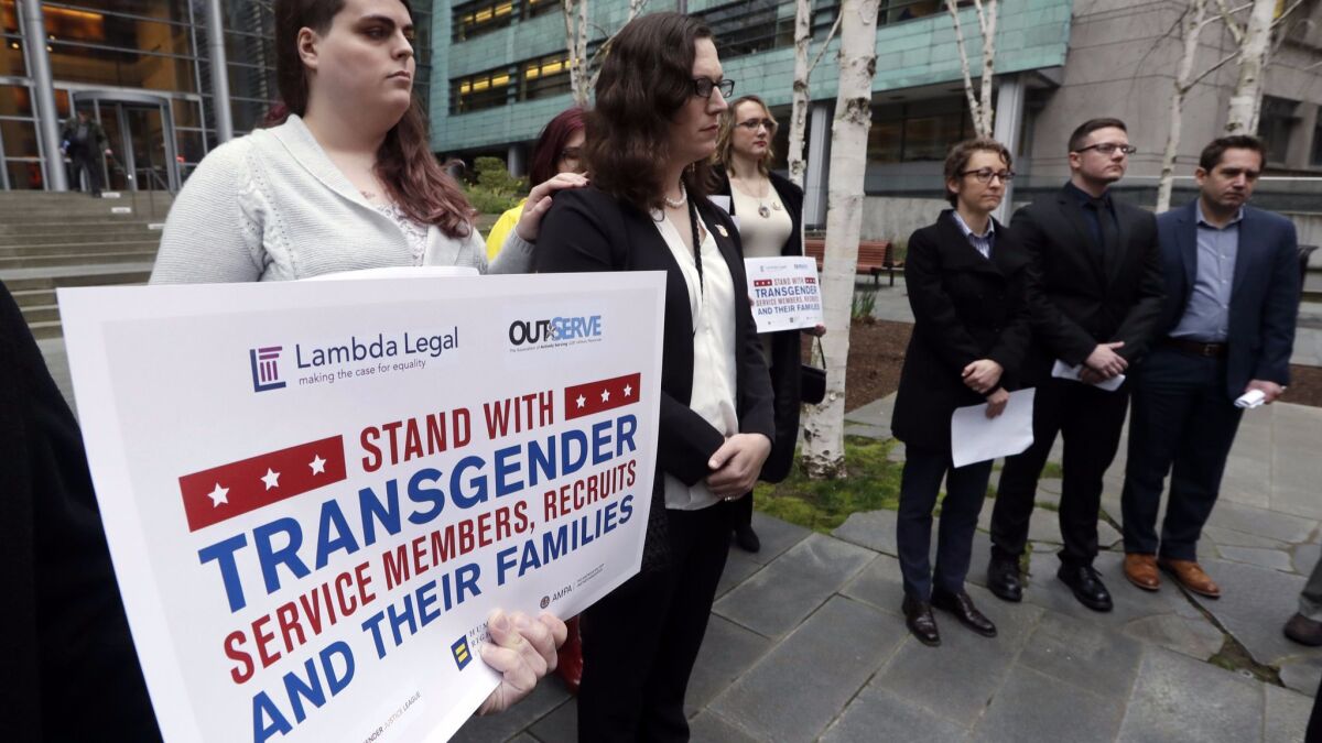 Plaintiffs Cathrine Schmid, second from left, and Conner Callahan, second from right, with supporters at a March 2018 news conference.