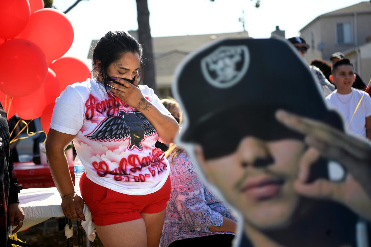 Leah Garcia cries for her late son, Paul Rea, during a vigil in Los Angeles.