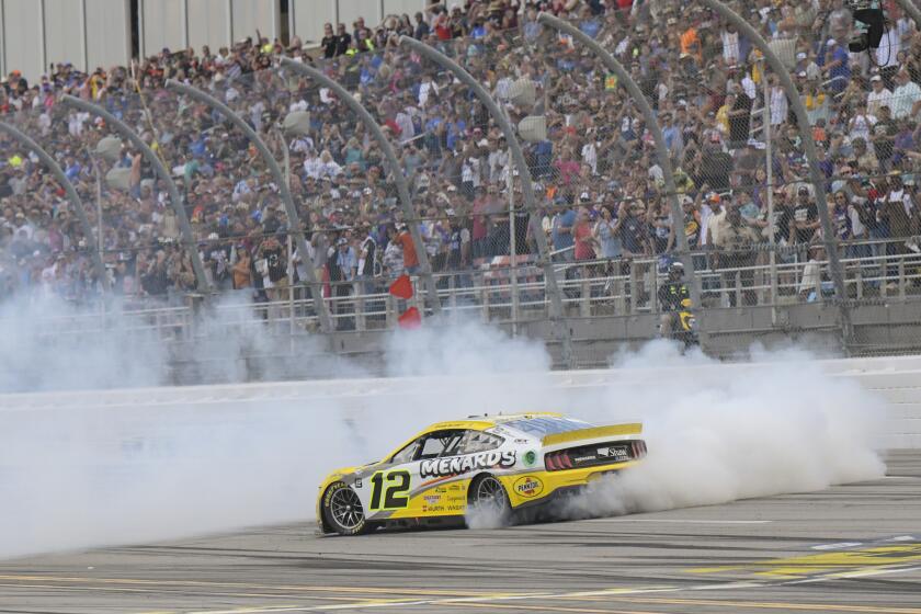 Ryan Blaney celebrates with a burnout on the track after winning a NASCAR Cup Series auto race at Talladega Superspeedway Sunday, Oct. 1, 2023, in Talladega, Ala. (AP Photo/Julie Bennett)