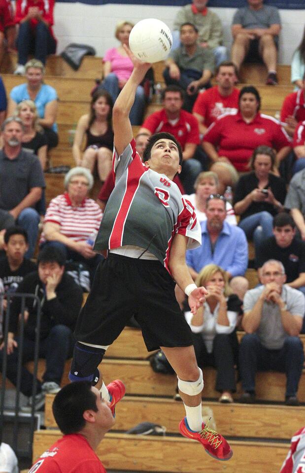 Burroughs' Jonathan Fuentes hits a kill attempt against Crescenta Valley in a Pacific League boys volleyball game at Crescenta Valley High School on Friday, April 11, 2014.