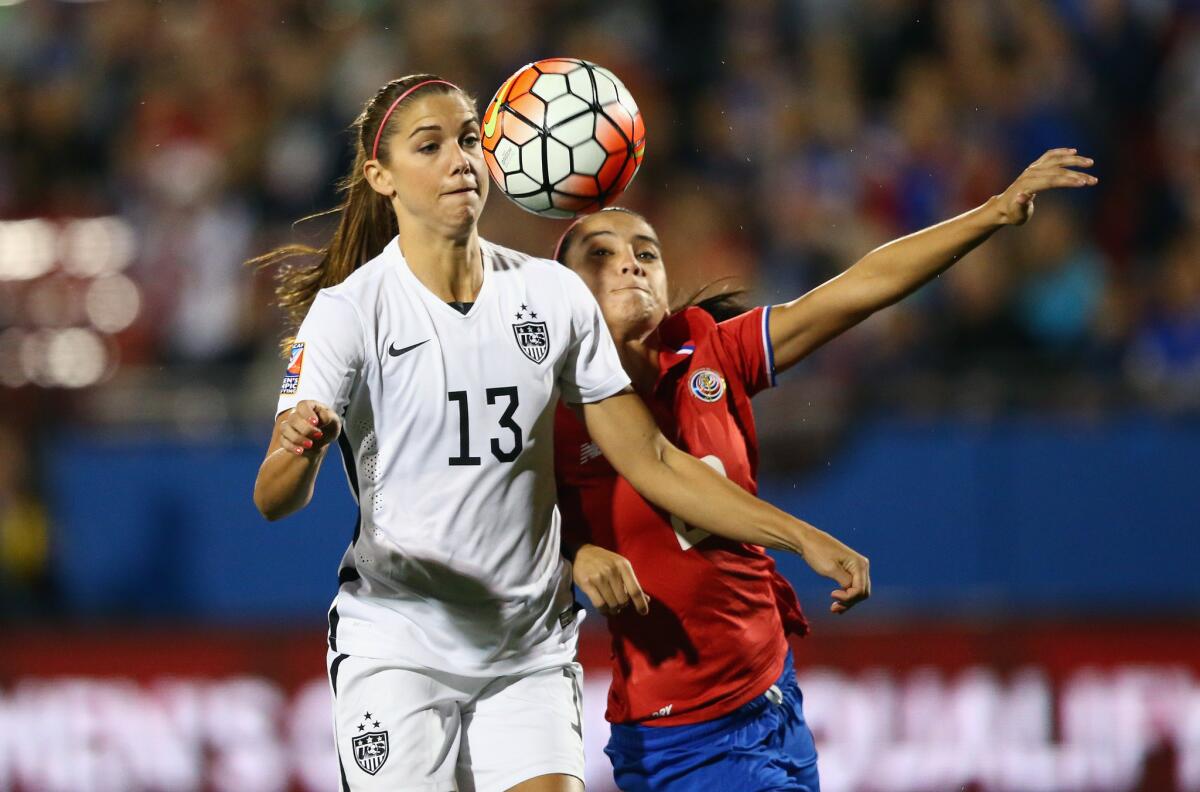 Alex Morgan scores a goal during the first minute of play in front of Costa Rica's Wendy Acosta (20) during an olympic qualifying match on Feb. 10.