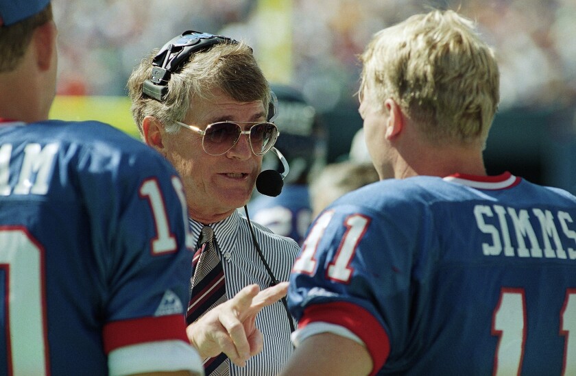FILE - New York Giants head coach Dan Reeves gives some instructions to his starting quarterback Phil Simms during the third quarter of their game against the Tampa Bay Buccaneers at Giants Stadium in East Rutherford, N.J. on Sunday, Sept. 12, 1993. Reeves, who won a Super Bowl as a player with the Dallas Cowboys but was best known for a long coaching career highlighted by four more appearances in the title game with the Denver Broncos and Atlanta Falcons, died Saturday, Jan. 1, 2022. (AP Photo/Mark Lennihan, File)