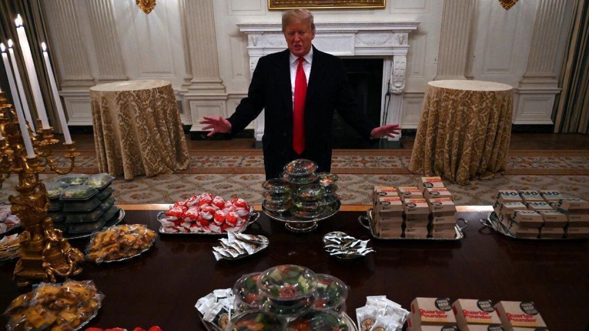 President Trump talks to the media about the table full of fast food in the State Dining Room prior to the Clemson Tigers' visit to the White House on Monday.