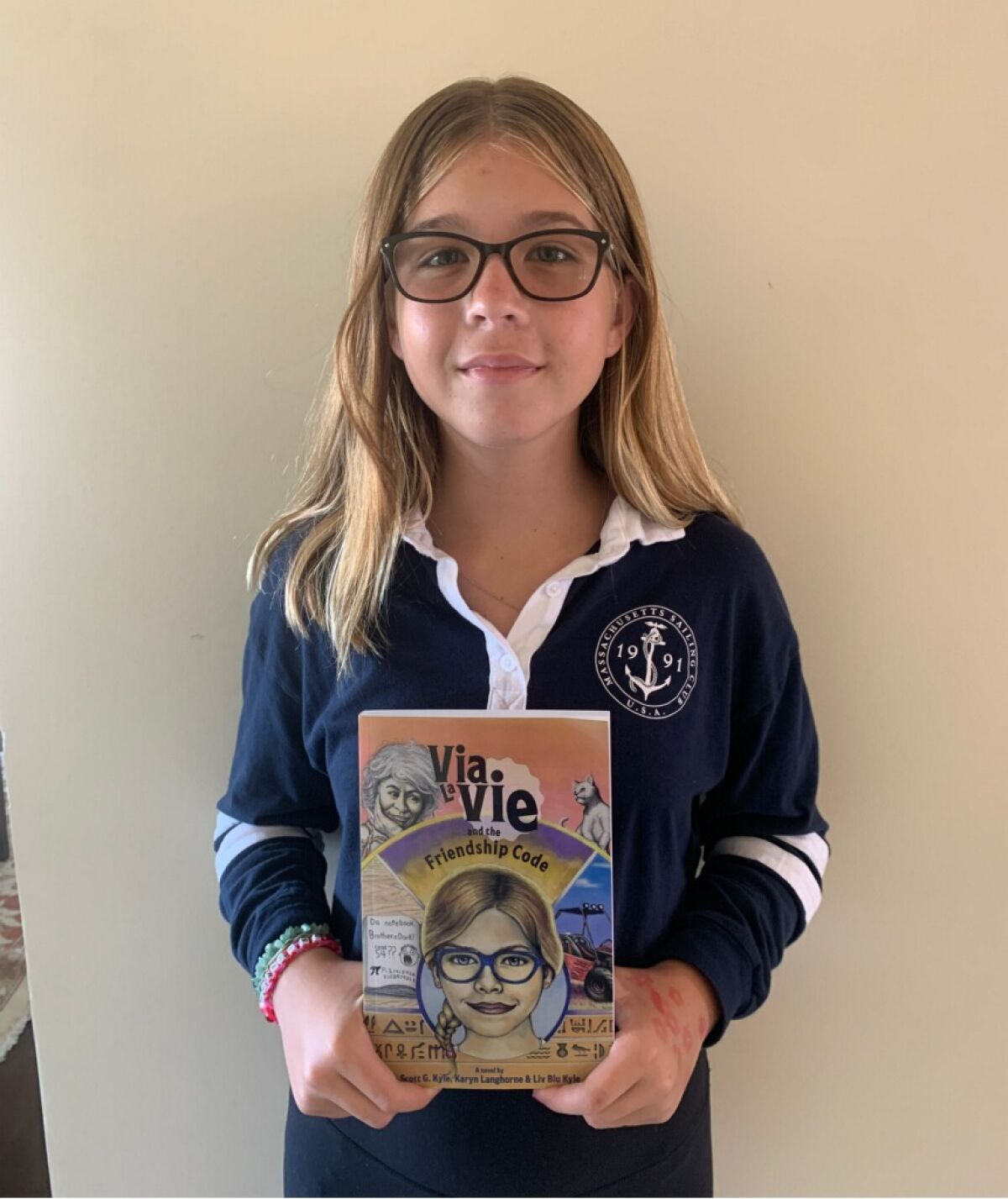 Muirlands Middle School student Liv Blu Kyle, 12, shows her book "Via LaVie and the Friendship Code."