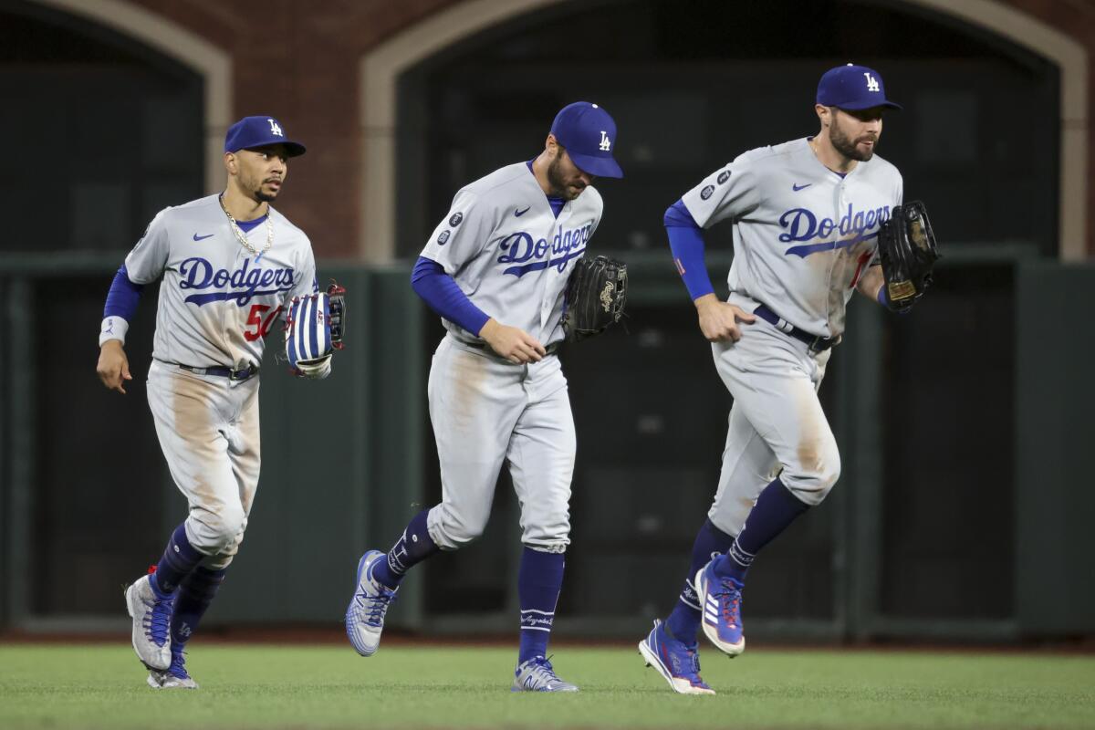 Three baseball players on a baseball field