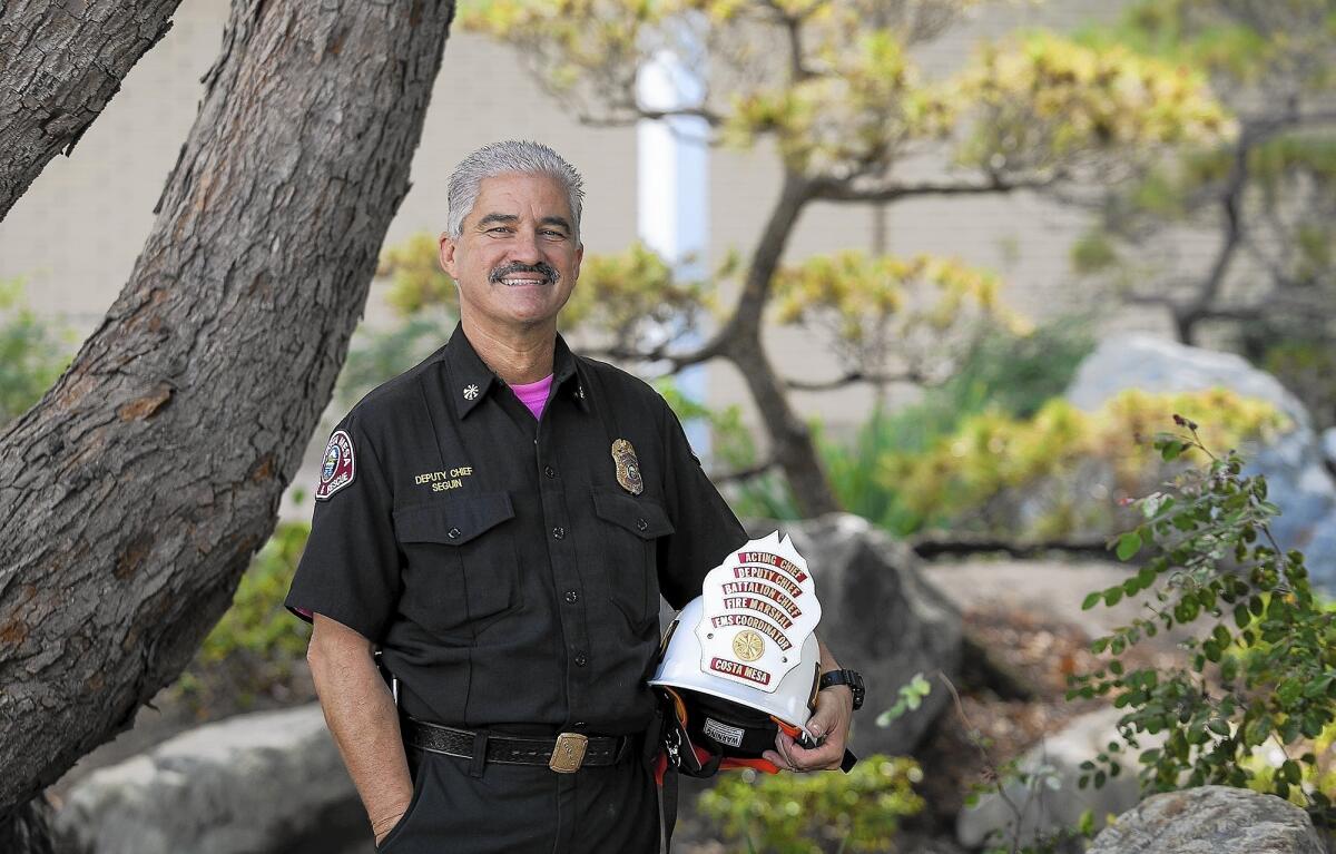 Fred Seguin, deputy chief of the Costa Mesa Fire Department, plans to retire Oct. 14 after 30 years with the city. The stack of patches on his helmet earned him the nickname "the pope" within the department.