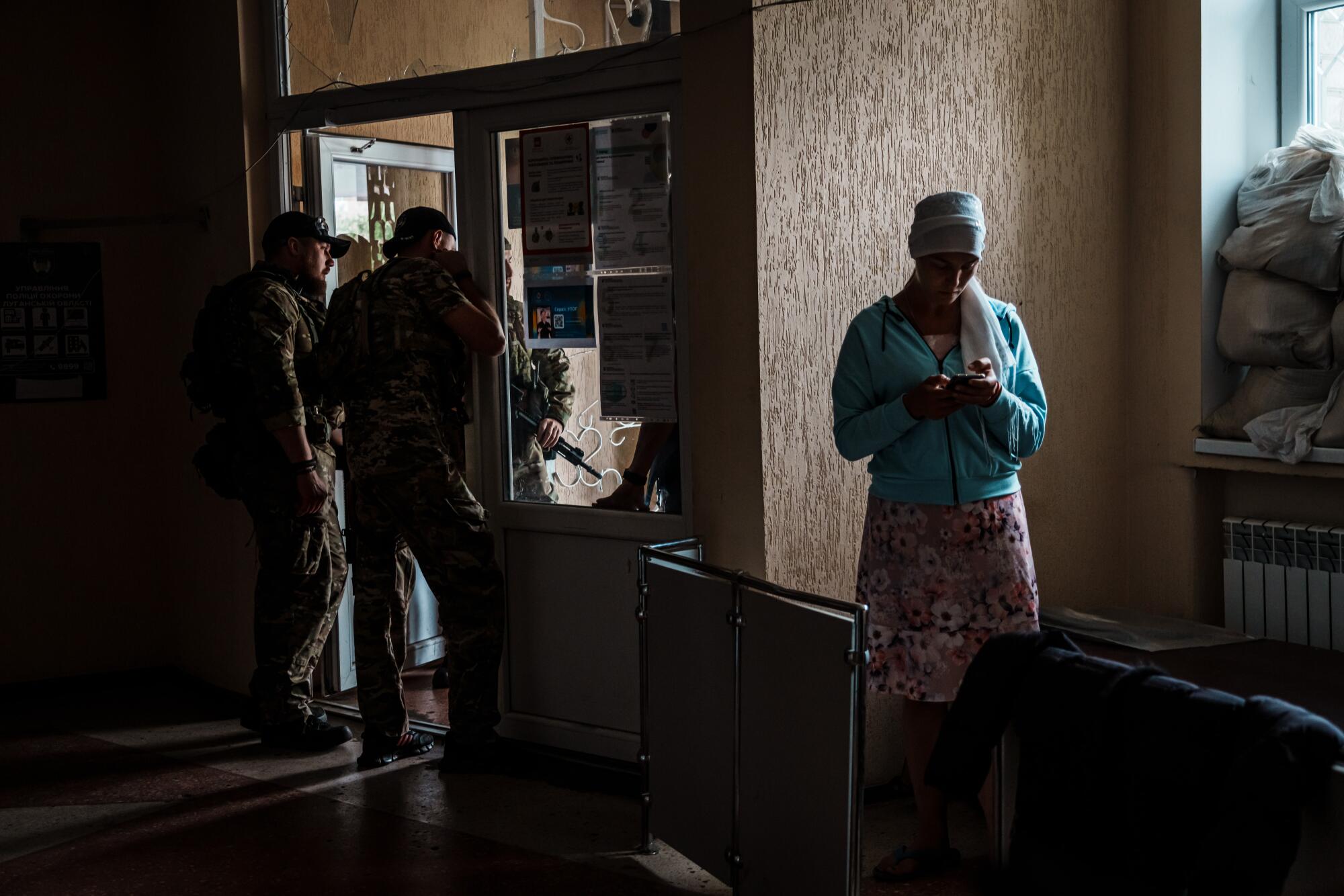 A woman tries to use her phone inside the police station