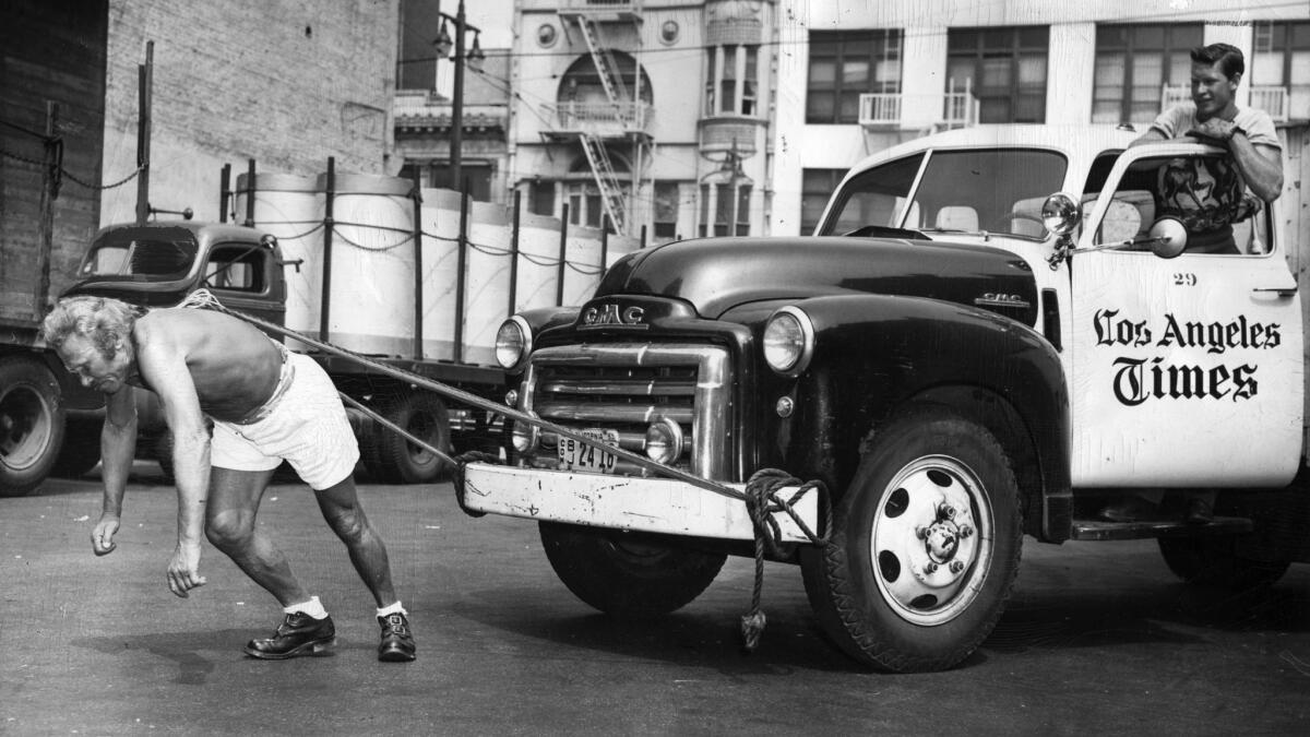 July 14, 1950: While Los Angeles Times truck driver Jessie Leon Moody watches, Leo V. Voss pulls two-ton delivery truck with a rope tied to his hair.