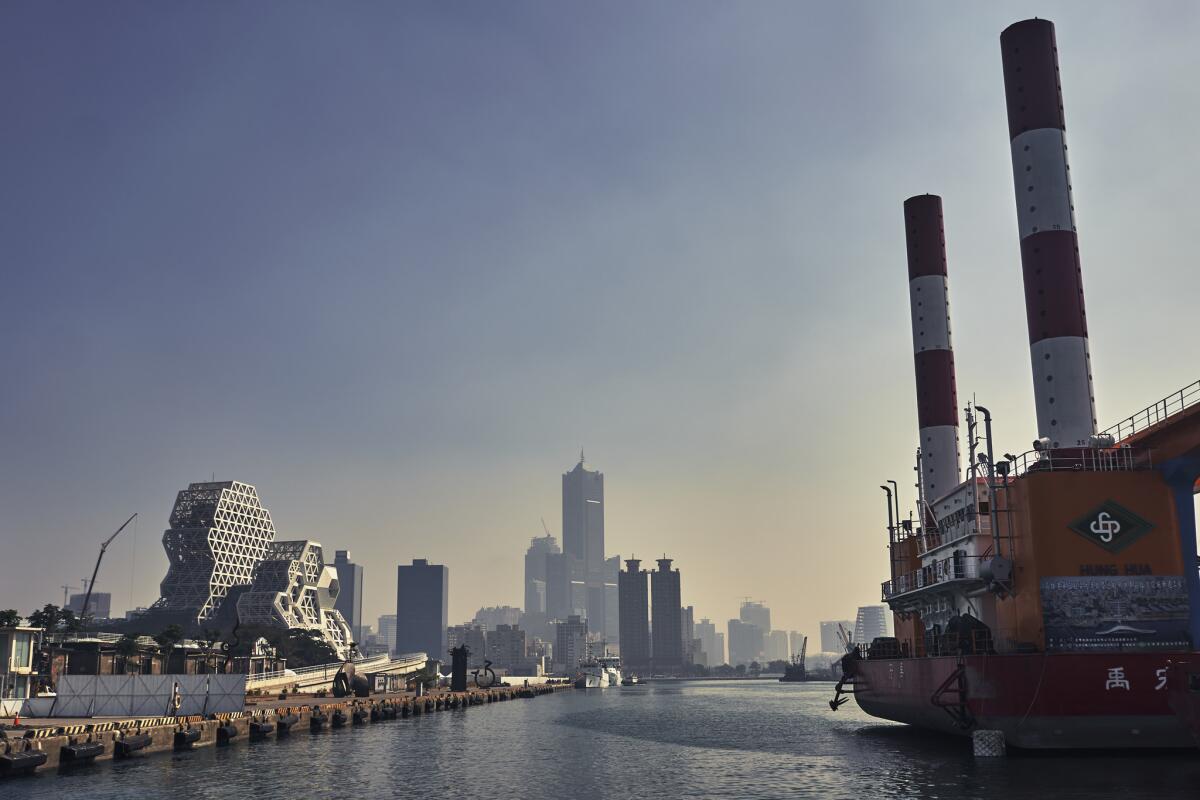 Cargo ships and oil rigs face the harbor at Sizih Bay in Kaohsiung, a heavy industry-centered city in southern Taiwan.