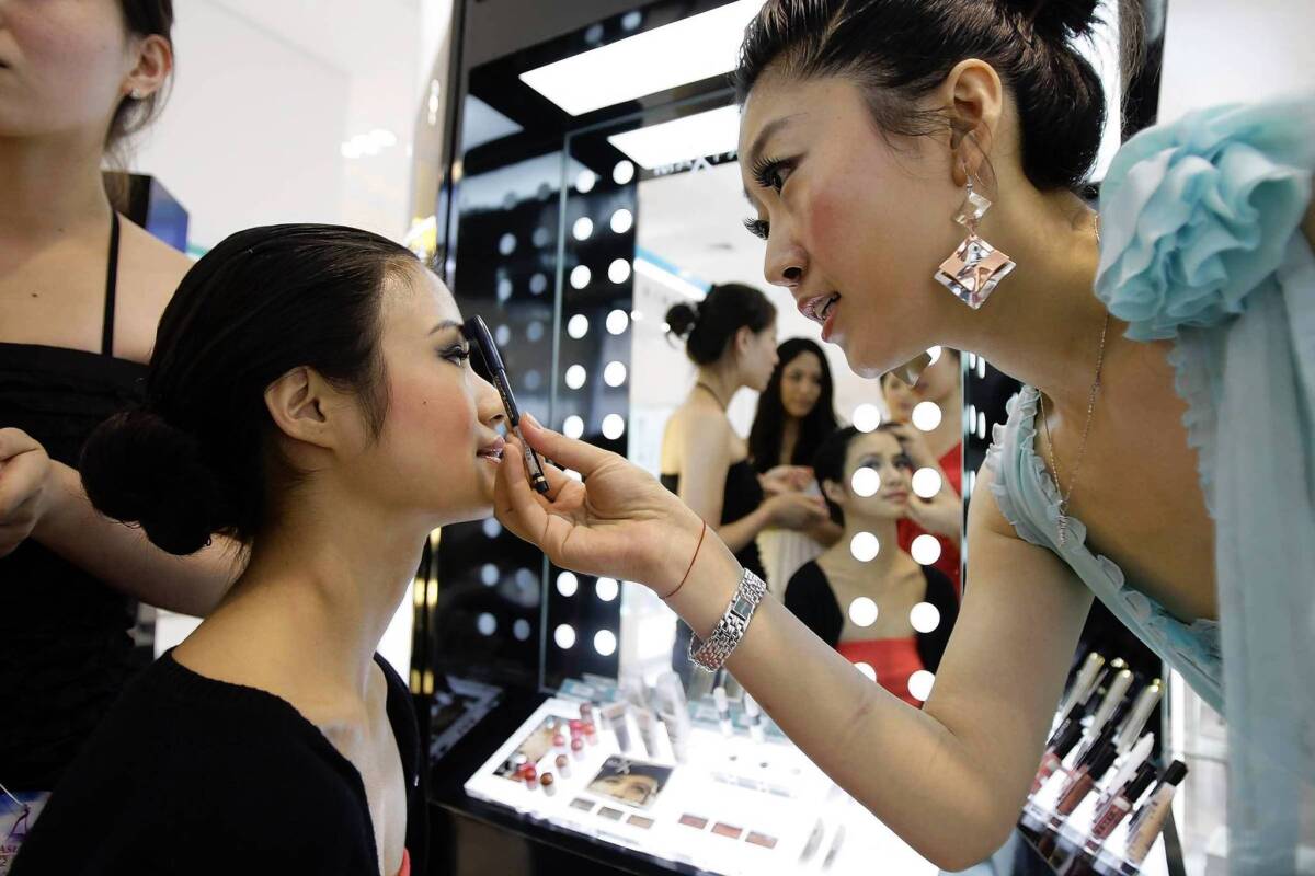 BB creams originally gained popularity in Asia, where whiter skin is especially prized. Here, Miss Asia Pageant contestants apply makeup during a promotional event at a Beijing department store.