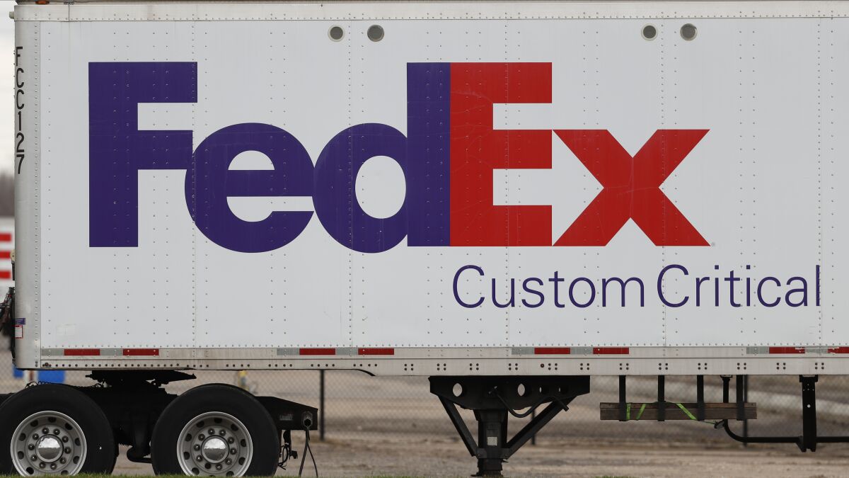 FILE - This April 1, 2020 file photo shows a FedEx logo at a facility in Romulus, Mich. Nearly two dozen FedEx packages have been found dumped in woods along a rural road in an Alabama town about 75 miles from a ravine where hundreds of undelivered FedEx parcels previously were discovered, police said Wednesday, Dec. 1, 2021. (AP Photo/Paul Sancya, file)