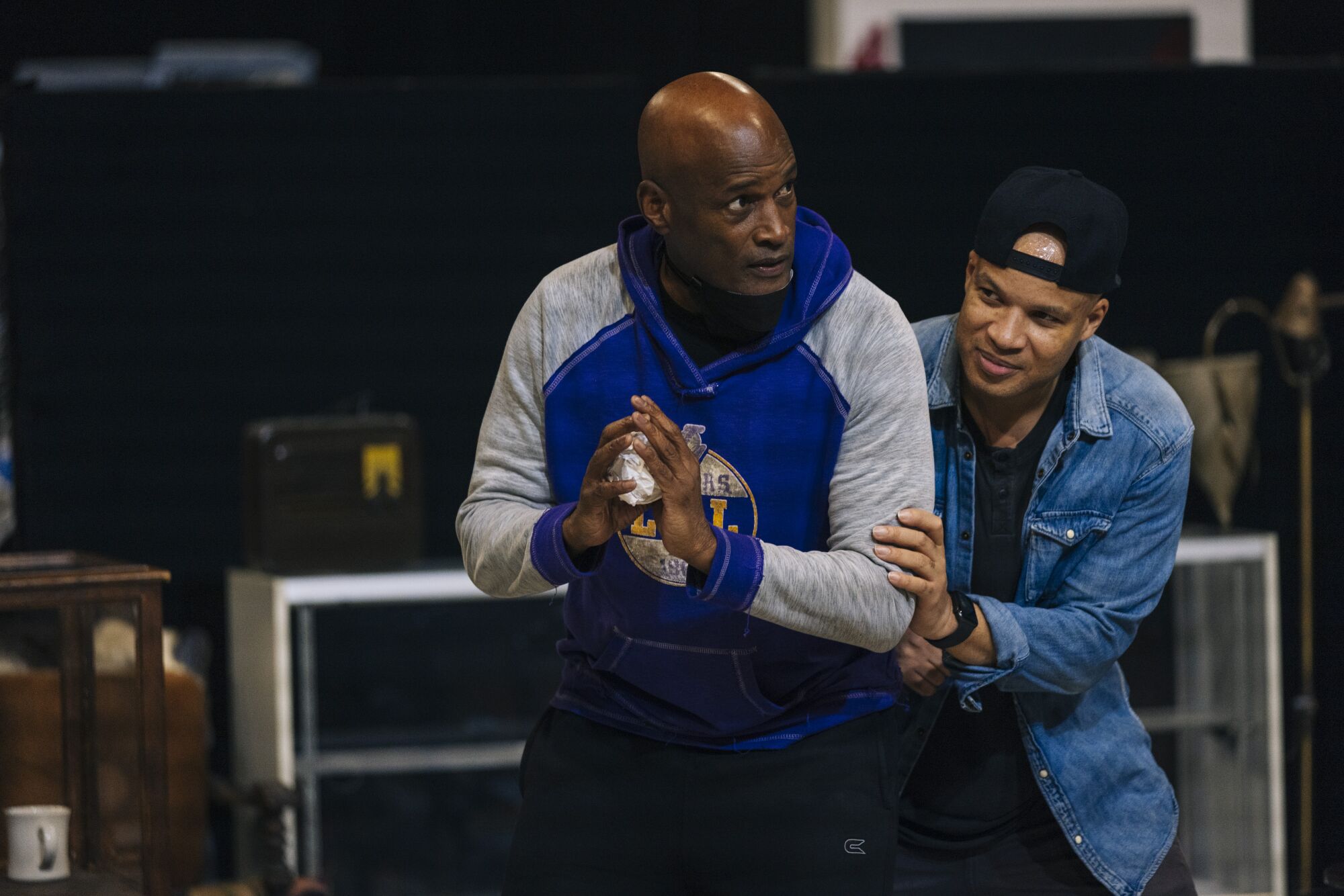 A director demonstrates a move, paired with an actor.
