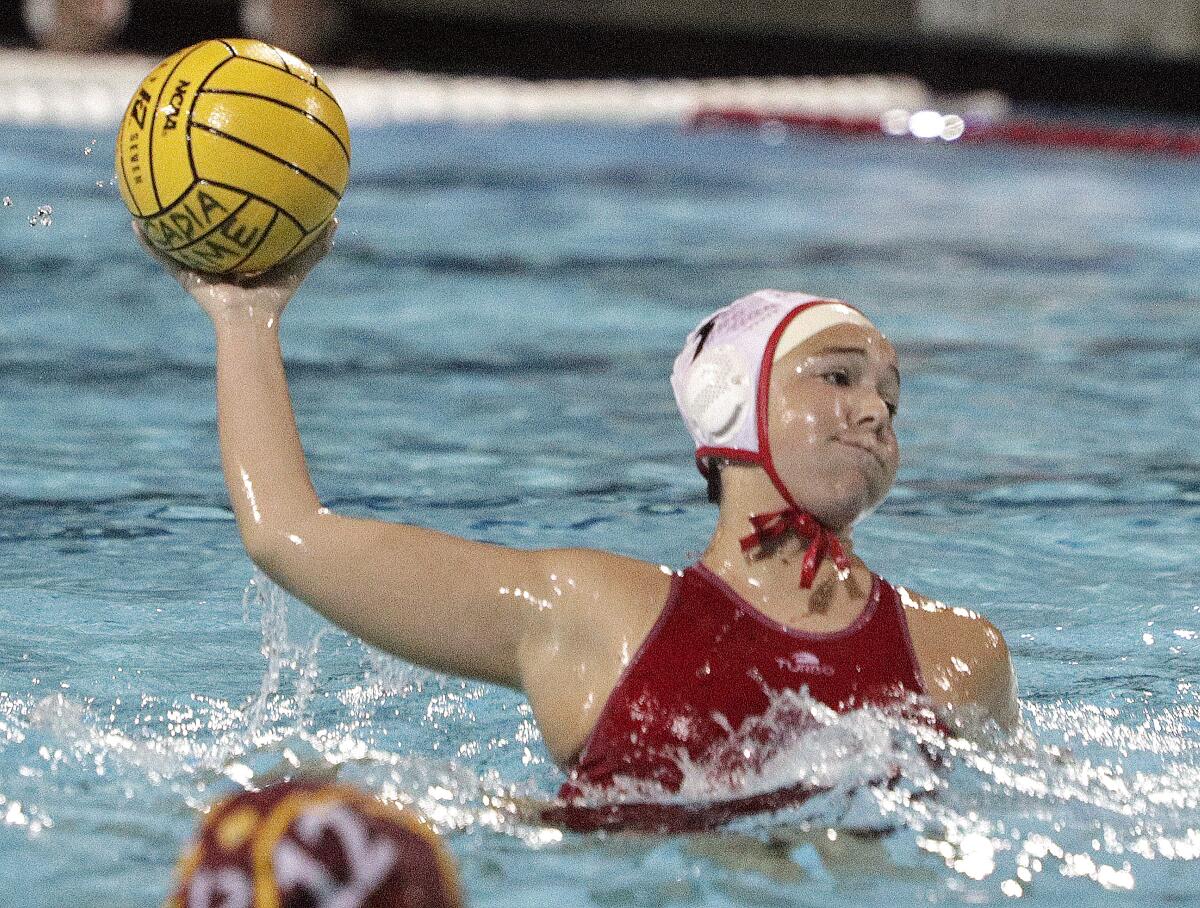 Burroughs' Clarissa Robles leans back and takes a shot as the shot clock was counting down and scores against Arcadia in the Pacific League girls' water polo championship at Arcadia High School on Thursday, February 6, 2020. Arcadia won the match in the second overtime.