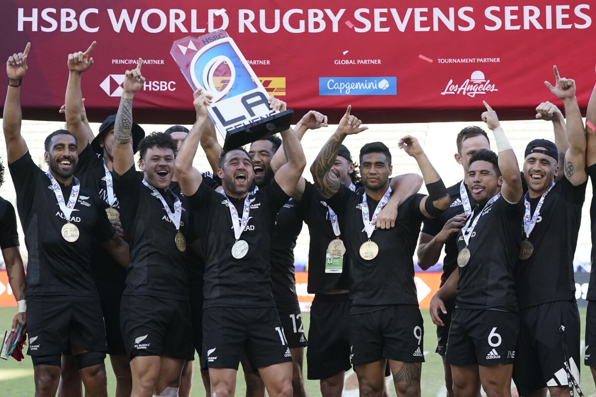 New Zealand's Kurt baker lifts the trophy for winning the Los Angeles rugby sevens series final.