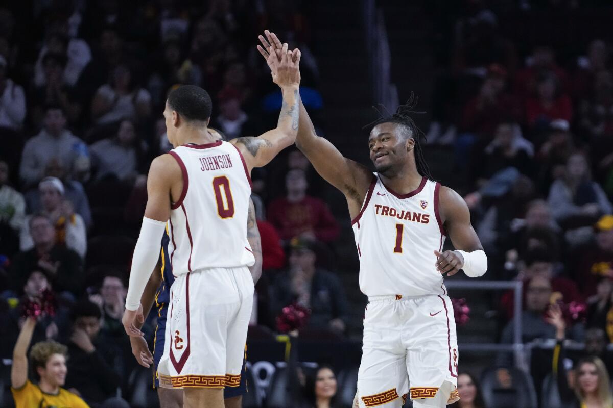 USC guard Isaiah Collier high fives guard Kobe Johnson during the team's win over Cal.