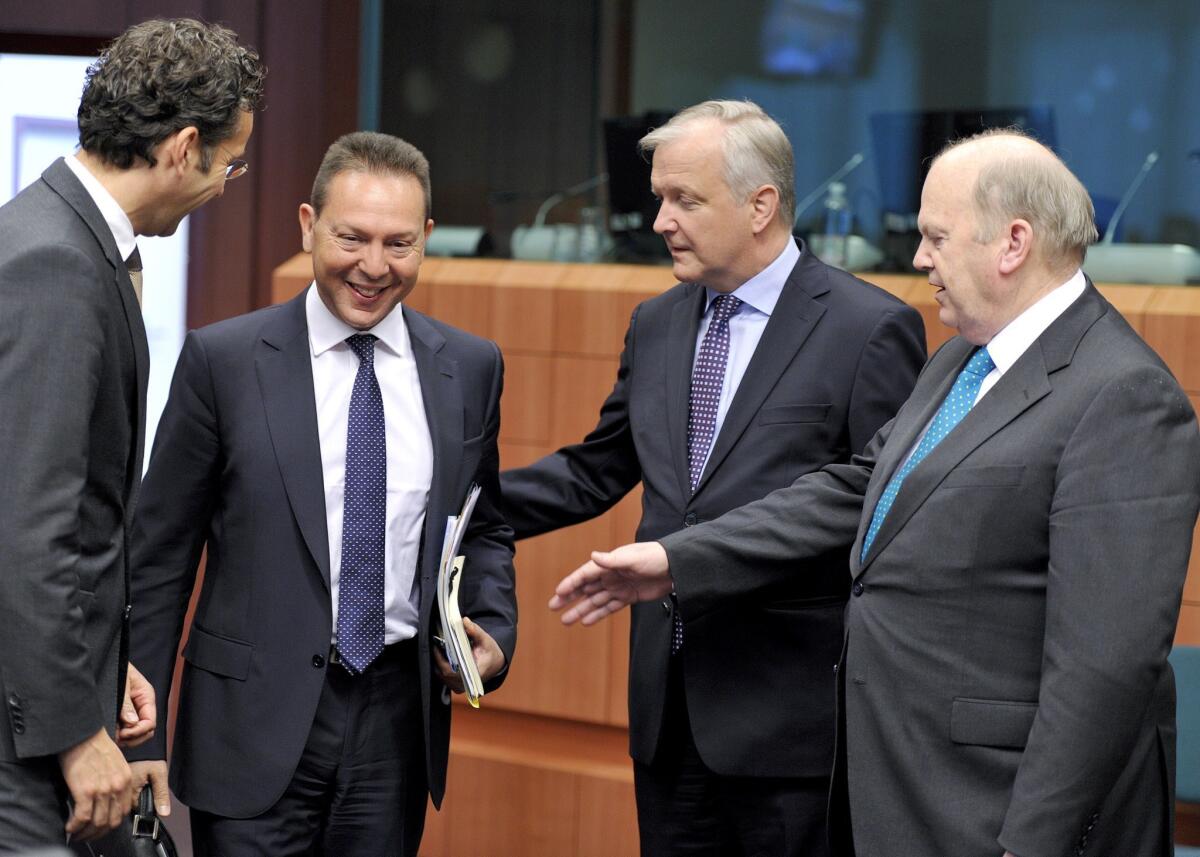 From left, Dutch Finance Minister Jeroen Dijsselbloem, Greek Finance Minister Yannis Stournaras, European Union Commissioner for Economic and Monetary Affairs Olli Rehn and Irish Finance Minister Michael Noonan talk prior to a Eurozone meeting at the EU headquarters in Brussels.