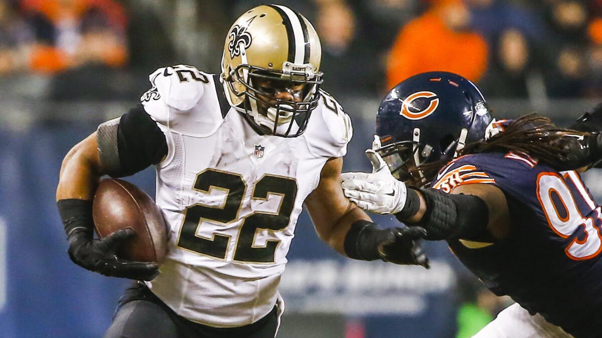 New Orleans Saints running back Mark Ingram, left, breaks away from Chicago Bears defensive end Willie Young during the Saints' 31-15 win Monday.