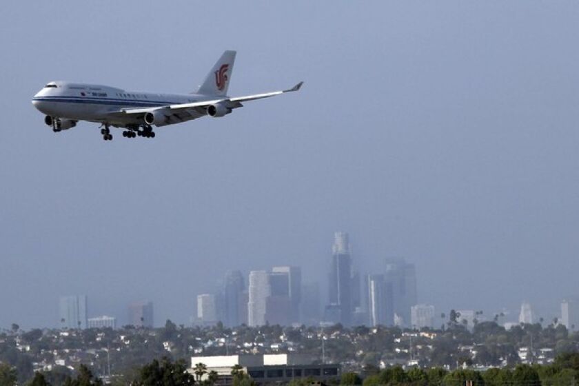 A 747 comes in for a landing at LAX with the downtown skyline as a backdrop. The best spots to watch planes? El Segundo's Imperial Hill area and next to the In-N-Out Burger on Sepulveda Boulevard.