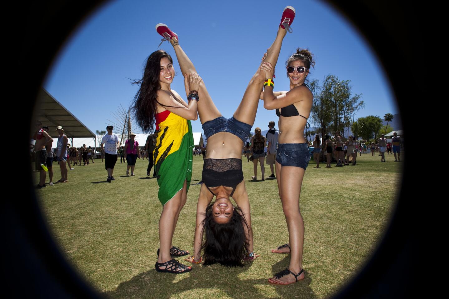 Aysha Quioz, 21, from left, Elizabeth Duran, 20 and Hayley Ferrano, 20, all from Riverside attending their first festival, pose for the Faces of Coachella gallery, on the first day of week two of the Coachella Valley Music and Arts Festival, 2012.