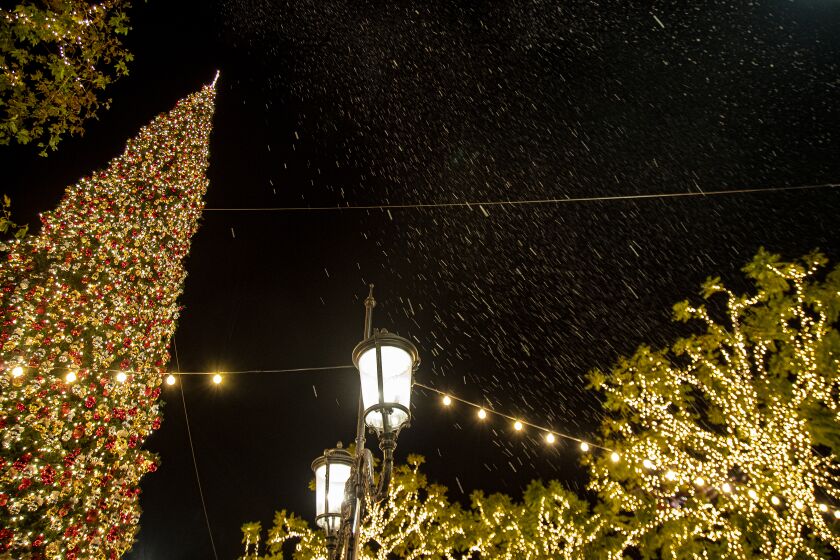 LOS ANGELES, CA - DECEMBER 18, 2019: Fake snow falls over the holiday scenes and decorations at The Grove on December 18, 2019 in Los Angeles, California. (Gina Ferazzi/Los AngelesTimes)
