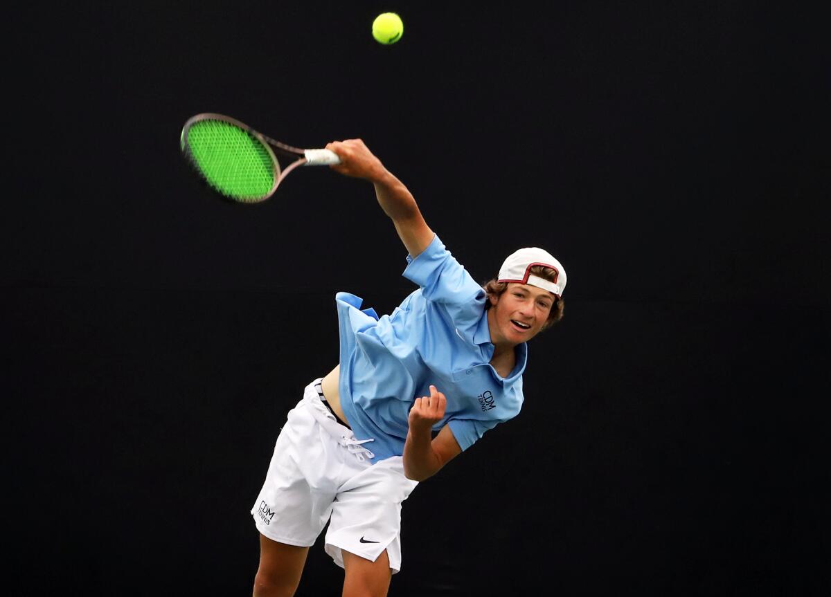 Corona del Mar's Niels Hoffmann serves against Woodbridge's Avery Tallakson.