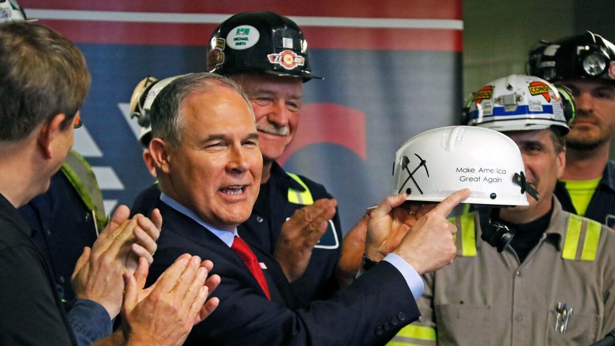 Environmental Protection Agency Administrator Scott Pruitt holds up a "Make America Great Again" hardhat he was given during a visit to a coal mine in Sycamore, Pa. on April 13.