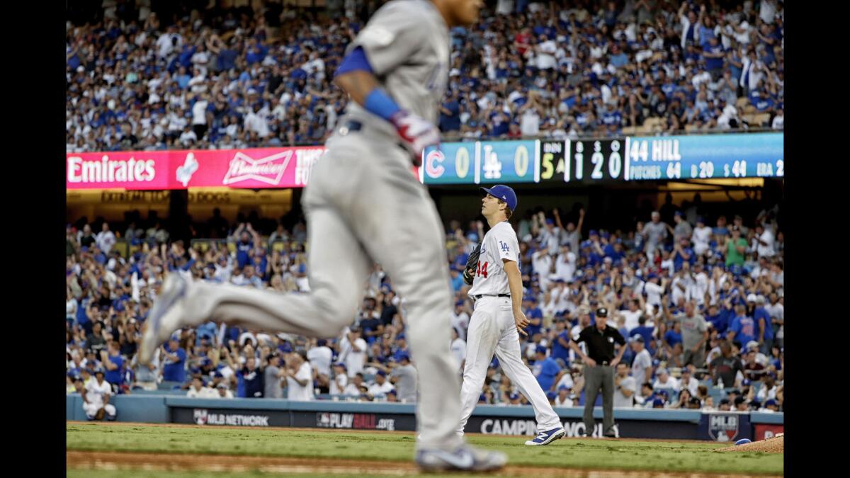 Dodgers pitcher Rich Hill can't watch as Cubs shortstop Addison Russell rounds third base after hitting a fifth-inning homer.