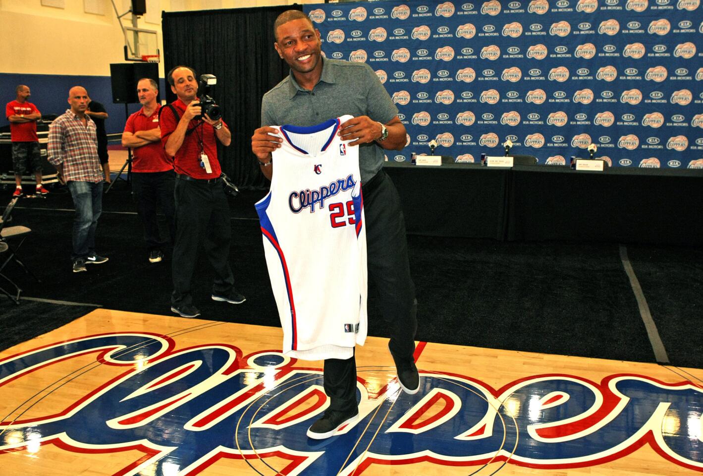 Former Boston Celtics coach Glenn "Doc" Rivers holds a Clippers jersey with his number and name on it while meeting members of the press introducing him as the new coach of the Los Angeles Clippers at the Clippers Training facility in Playa Vista.