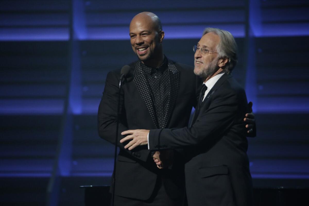 Common, left, and former Recording Academy President Neil Portnow at the 58th Grammy Awards.