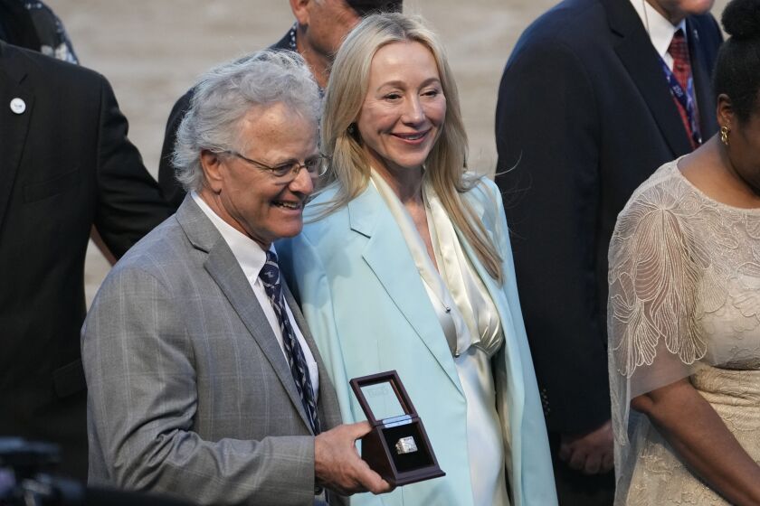 Belinda Stronach, CEO and president of 1/ST, right, stands in the winner's circle with Bill Mott, trainer of the horse Art Collector won the Pegasus World Cup Invitational horse race, Saturday, Jan. 28, 2023, at Gulfstream Park in Hallandale Beach, Fla. (AP Photo/Lynne Sladky)