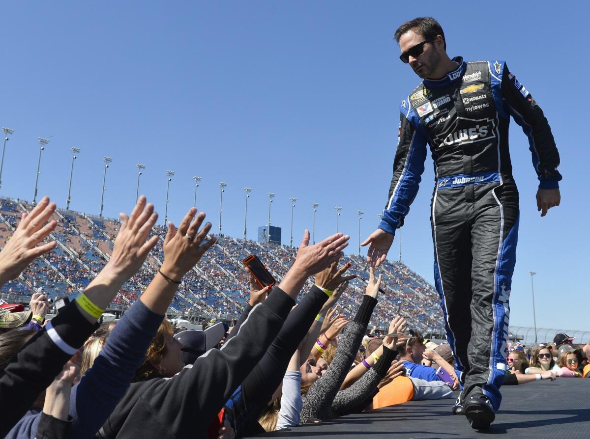Jimmie Johnson greets fans during driver introductions ahead of a NASCAR Sprint Cup race at Chicagoland Speedway in Joliet, Ill. on Sept. 14.