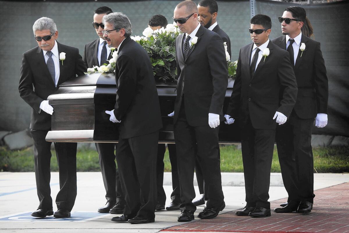 Robert Velasco, far left, is among the pallbearers at the funeral of his daughter Yvette at Forest Lawn - Covina Hills.