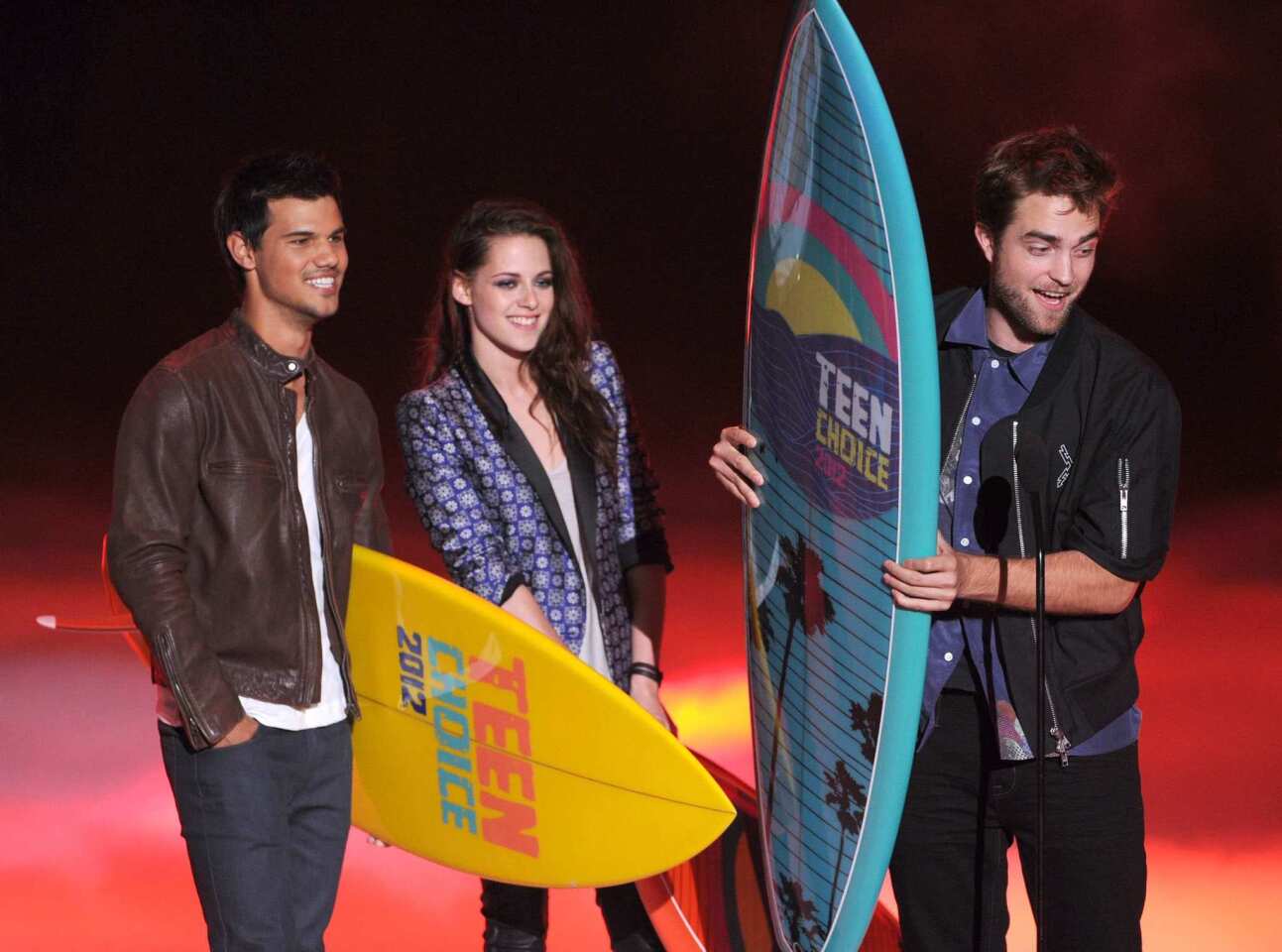 "The Twilight Saga" continues its long road to retirement as Taylor, Kristen and Robert appear at the 2012 Teen Choice awards to collect trophies. Two days after the ceremony, Stewart's romantic outing with "Snow White and The Huntsman" director Rupert Sanders would be revealed.