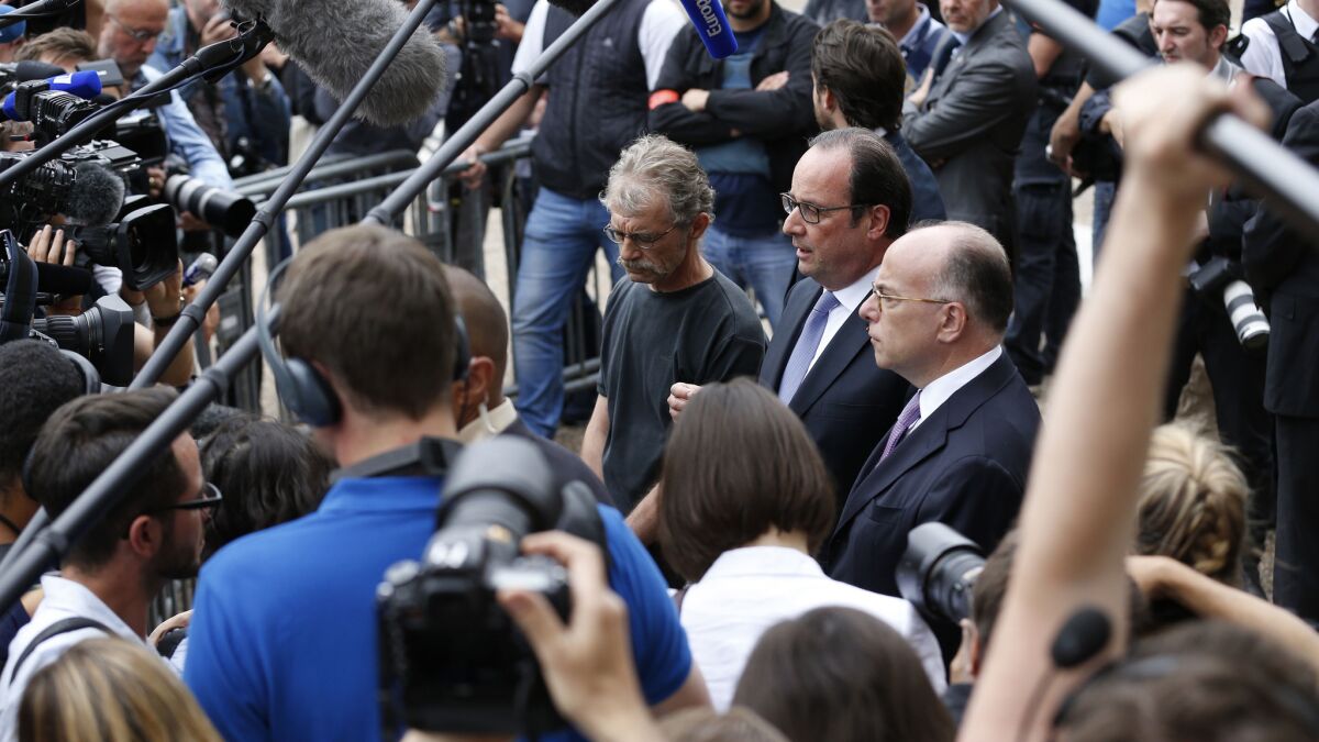 French President Francois Hollande speaks to the media as he leaves City Hall in St.-Etienne-du-Rouvray.