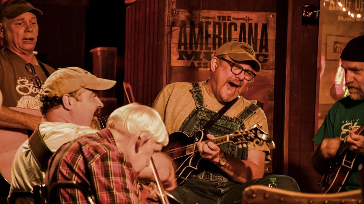 The Station Inn, a favorite Nashville roots music venue, holds bluegrass jam sessions on Sunday nights. Here, Carl Caldwell sings and plays mandolin.