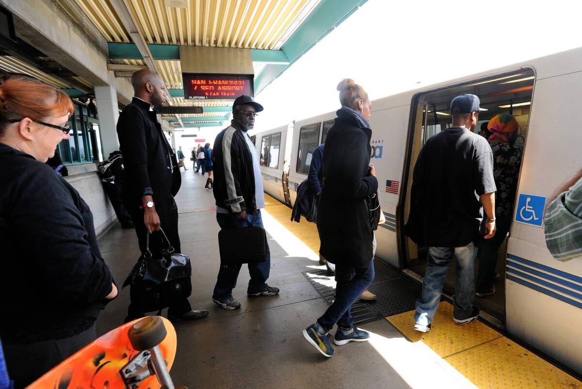 Passengers board the first train headed into San Francisco at the West Oakland BART station on Friday. Commuter rail service resumed Friday after a five-day strike when workers' existing contract was extended to Aug. 4.