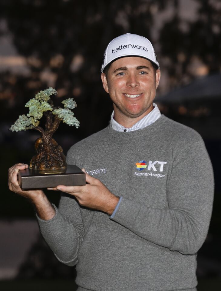 Luke List holds the championship trophy after winning the Farmers Insurance Open golf tournament on Jan. 29 in La Jolla.