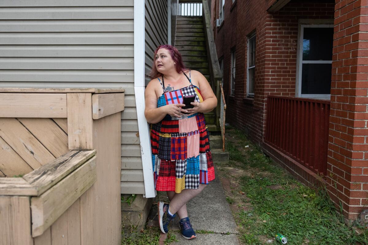 Amanda Leffler stands in front of the apartment.