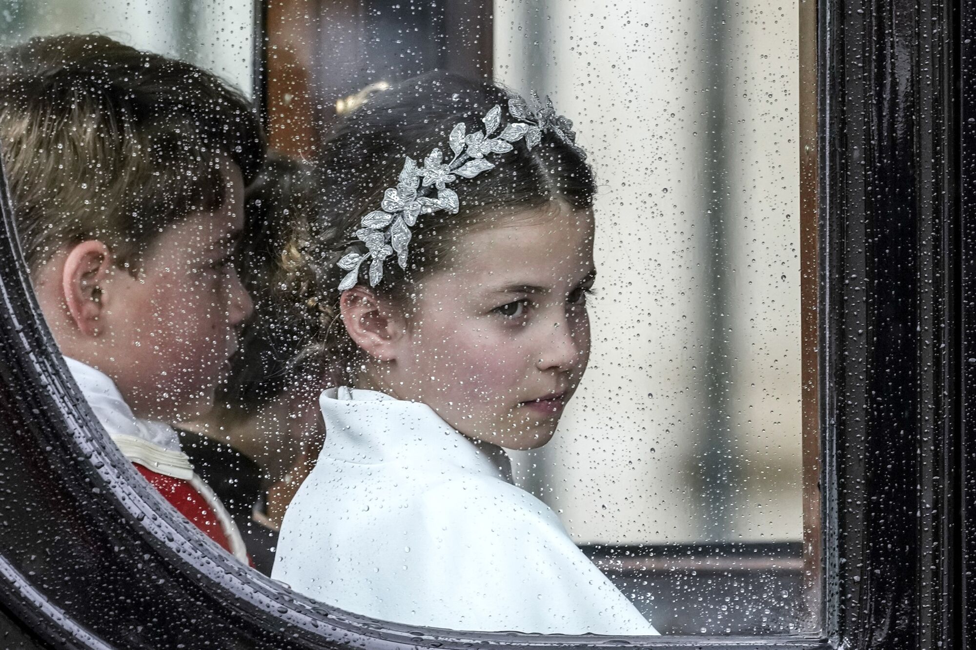 Princess Charlotte, right, and Prince George depart Westminster Abbey after the coronation ceremony.